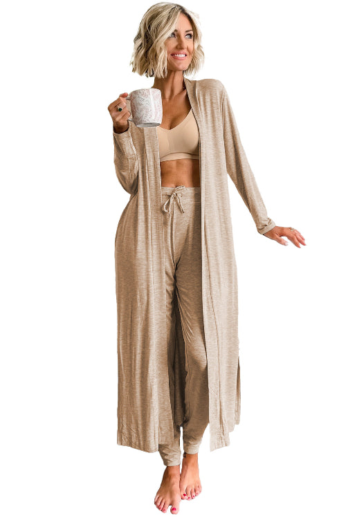 Woman in beige loungewear set holding a mug on a white background