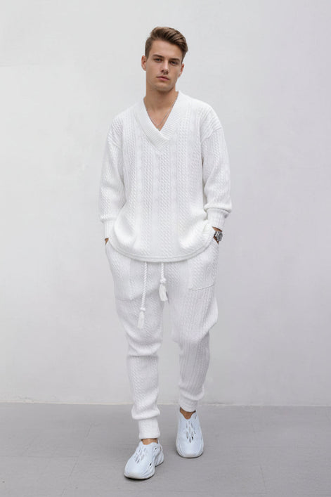 A person wearing a matching white knit lounge set consisting of a long-sleeve V-neck sweater and jogger pants, 