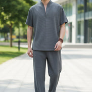 Person wearing a gray outfit in a modern interior setting