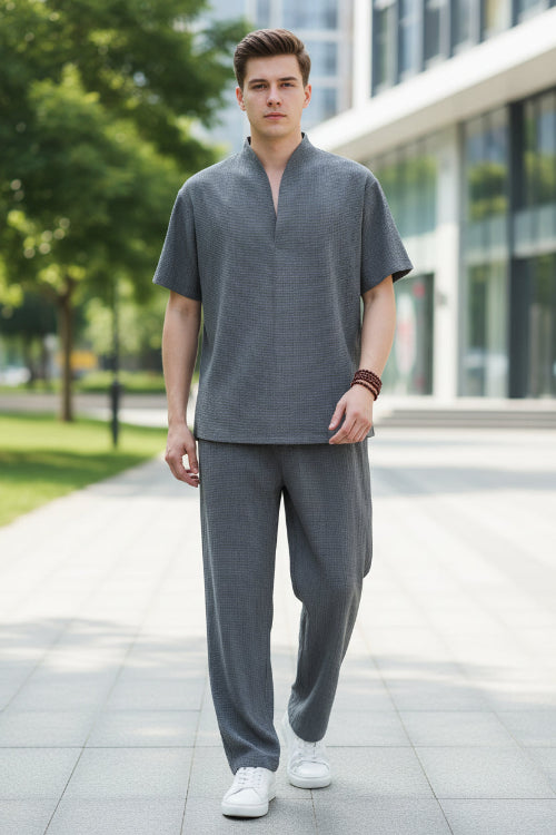 Person wearing a gray outfit in a modern interior setting
