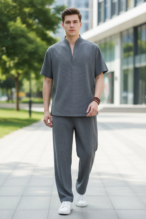 Person wearing a gray outfit in a modern interior setting