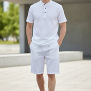 White shirt and pants set on hangers against a white background