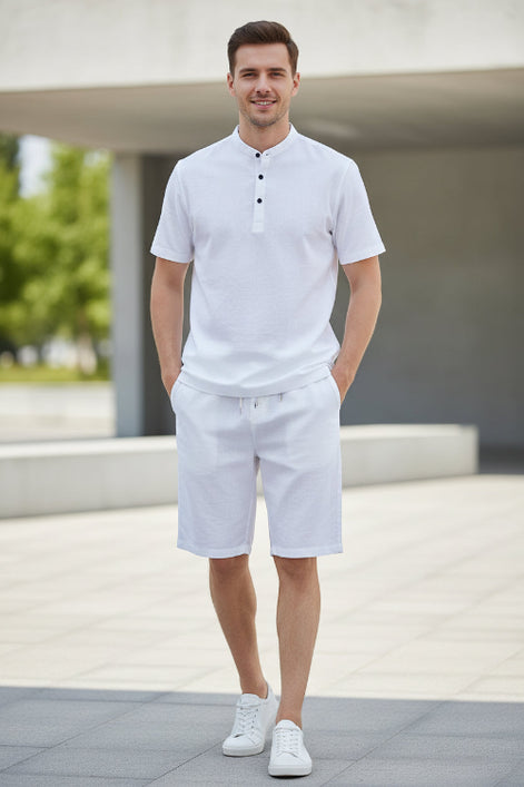 White shirt and pants set on hangers against a white background