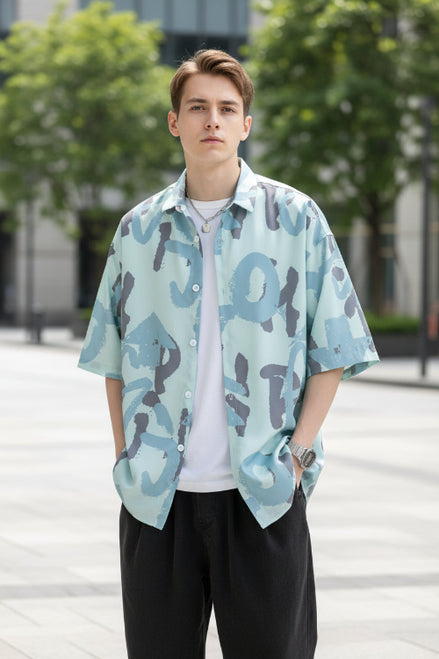 Person wearing a light blue camouflage shirt with a white undershirt.